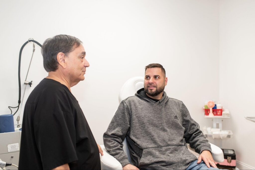 Dermatologist consulting with patient in a clinical setting at Chicago Skin Clinic, discussing skin examination and personalized treatment options.